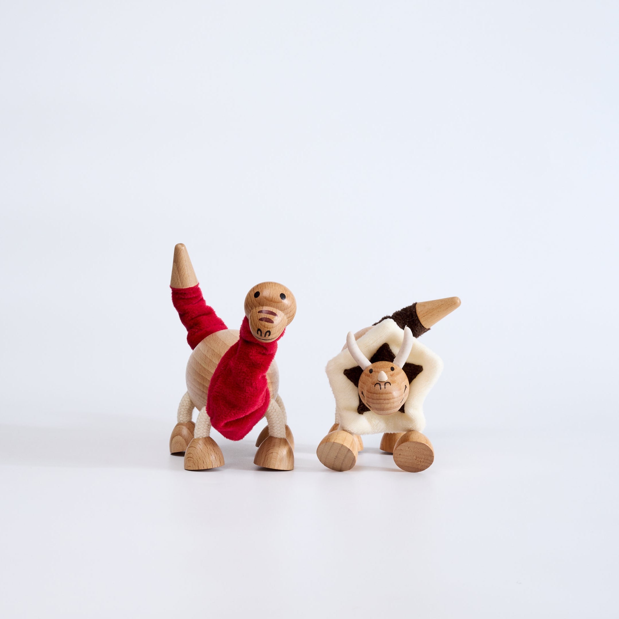Two toy figures pose on a white background