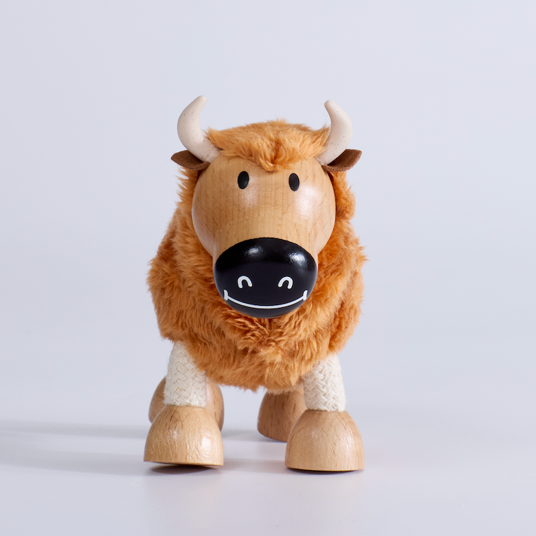 Wooden toy yak on a light gray background