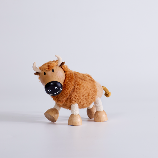 Wooden toy yak on a light gray background