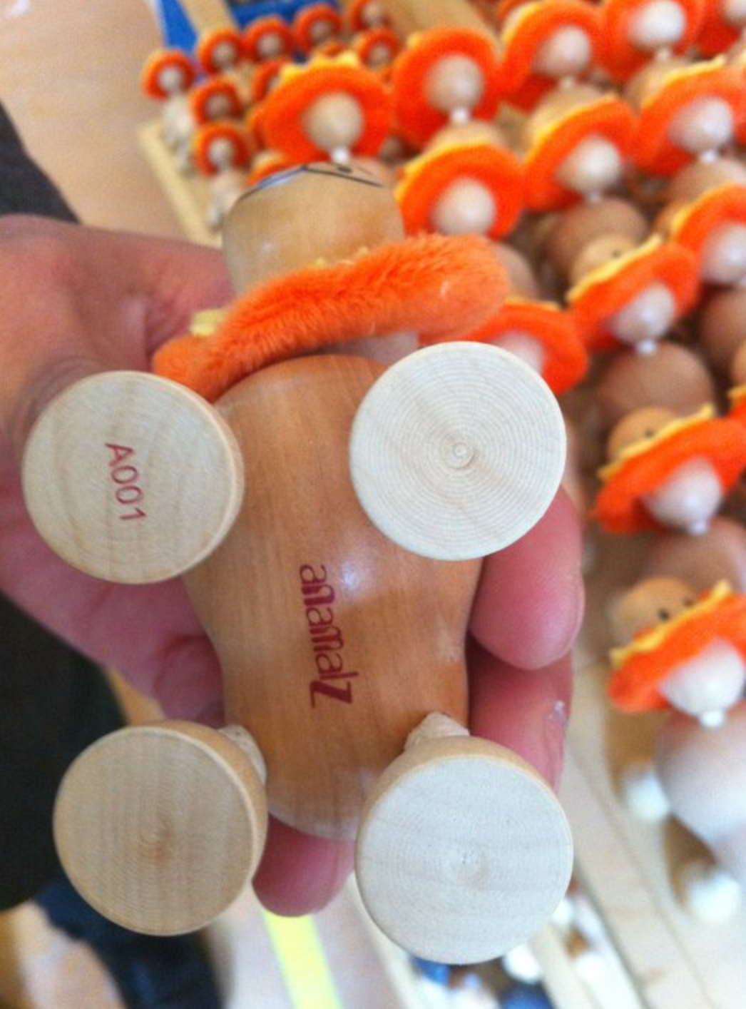 bottom of wooden lion toy showing anamalz logo