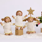 Three Cherub Angels in white and gold dresses with a gold star and present block in a snowy Christmas scene
