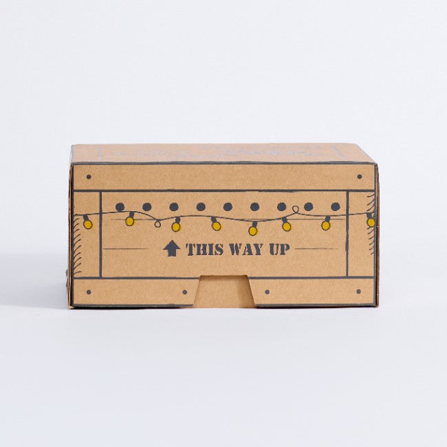 Cherub Angels Christmas gift box showing the illustrated string lights and This Way Up panel