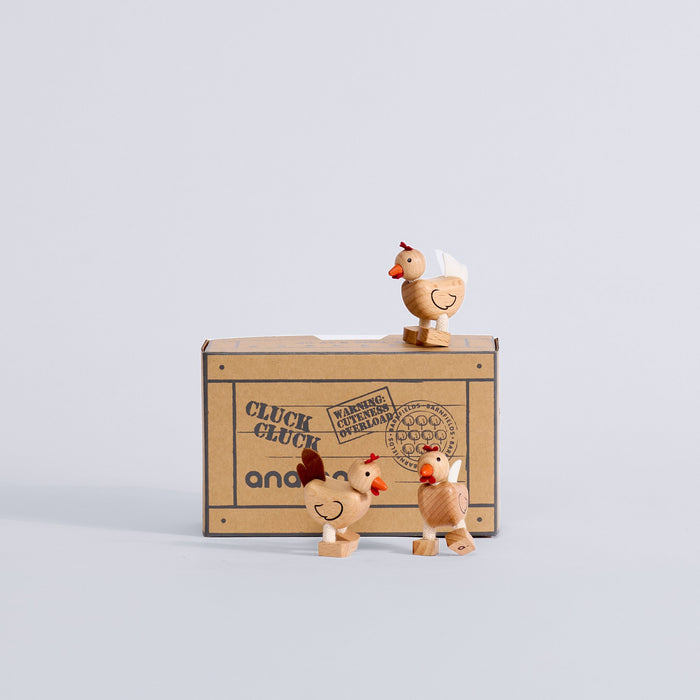 Three Chicken Trio wooden chickens displayed with their box