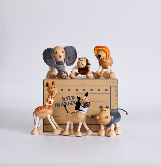 Set of wooden animal figurines in a box with 'Wild Transport' label on a white background