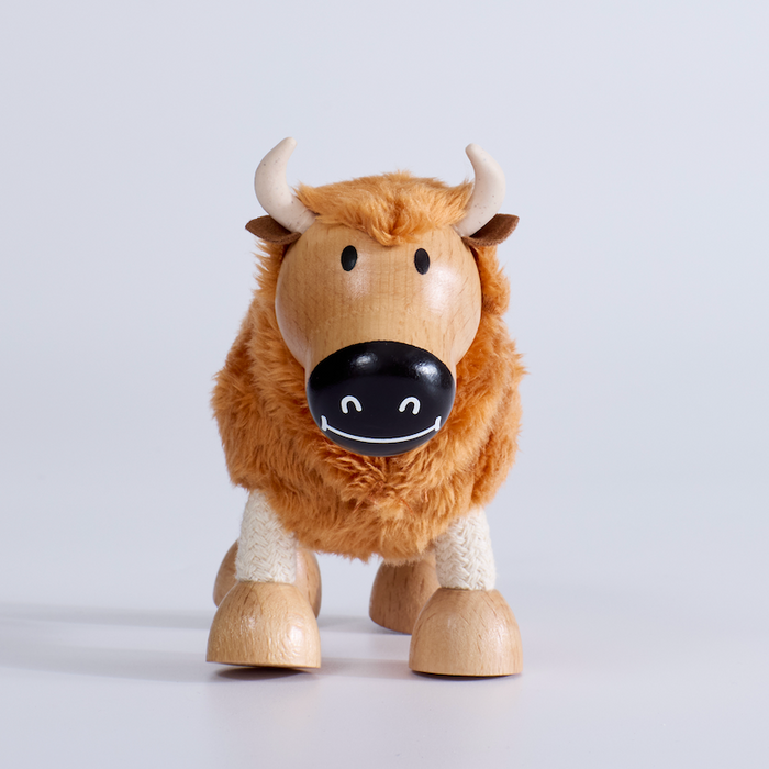 Wooden toy yak on a light gray background
