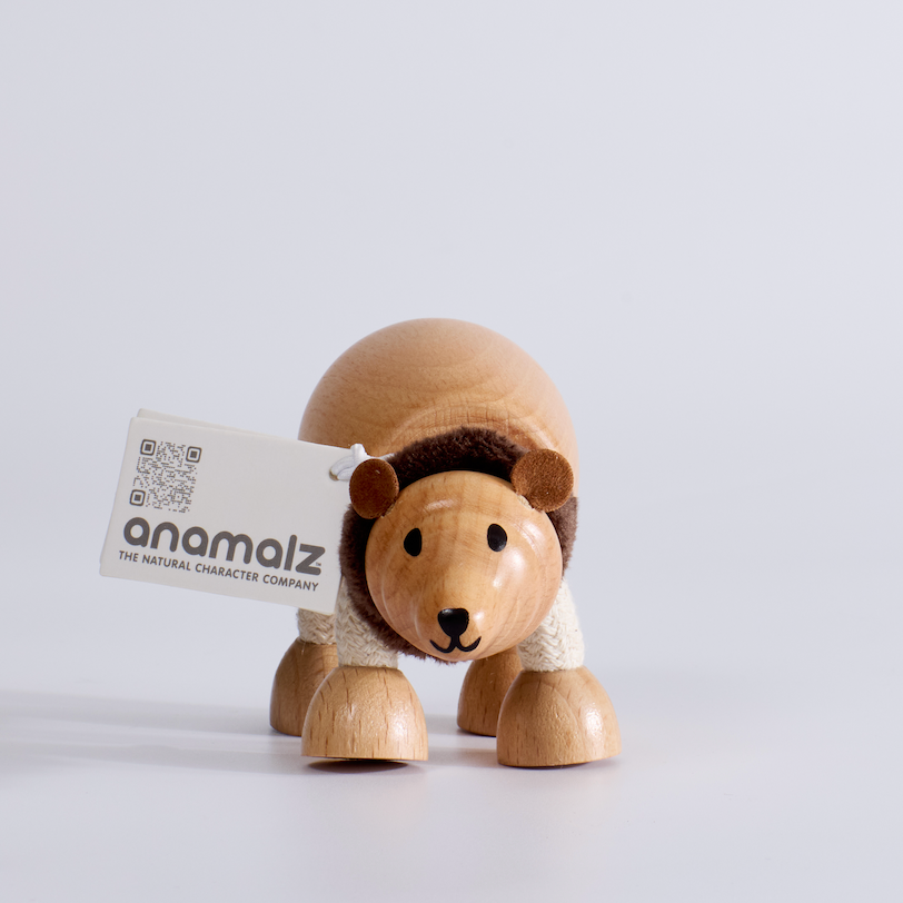 Wooden hedgehog toy with a card labeled 'anomalz' on a white background