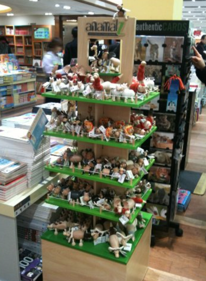 display stand with wooden animal toys on it