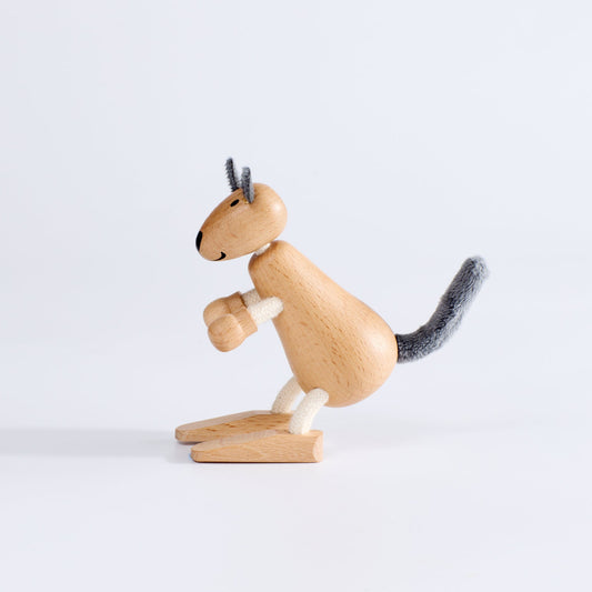 A wooden toy kangaroo with plush fabric and rope, standing upright on a white background.