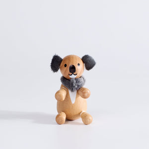 A wooden toy koala with plush fabric ears 