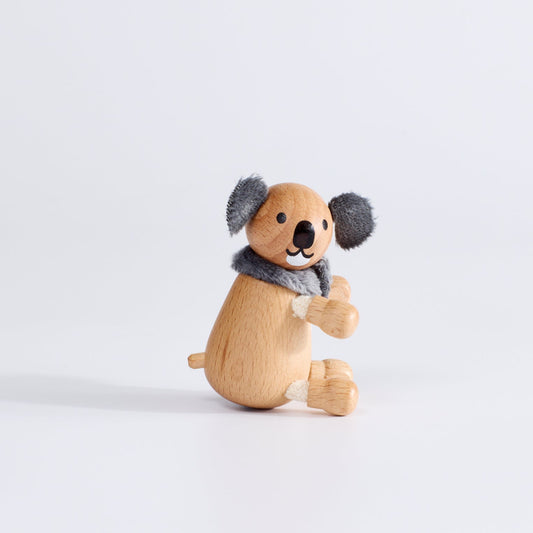 A wooden toy koala with plush fabric ears 