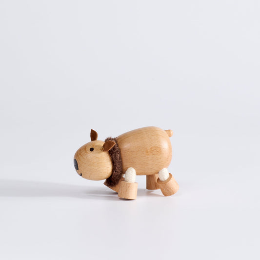 A handcrafted wooden toy wombat with a soft scarf, displayed against a white background.