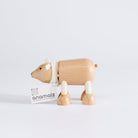 A wooden polar bear toy facing sideways, standing upright on a white background.