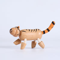Wooden tiger toy on a light gray background