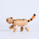 Wooden tiger toy on a light gray background
