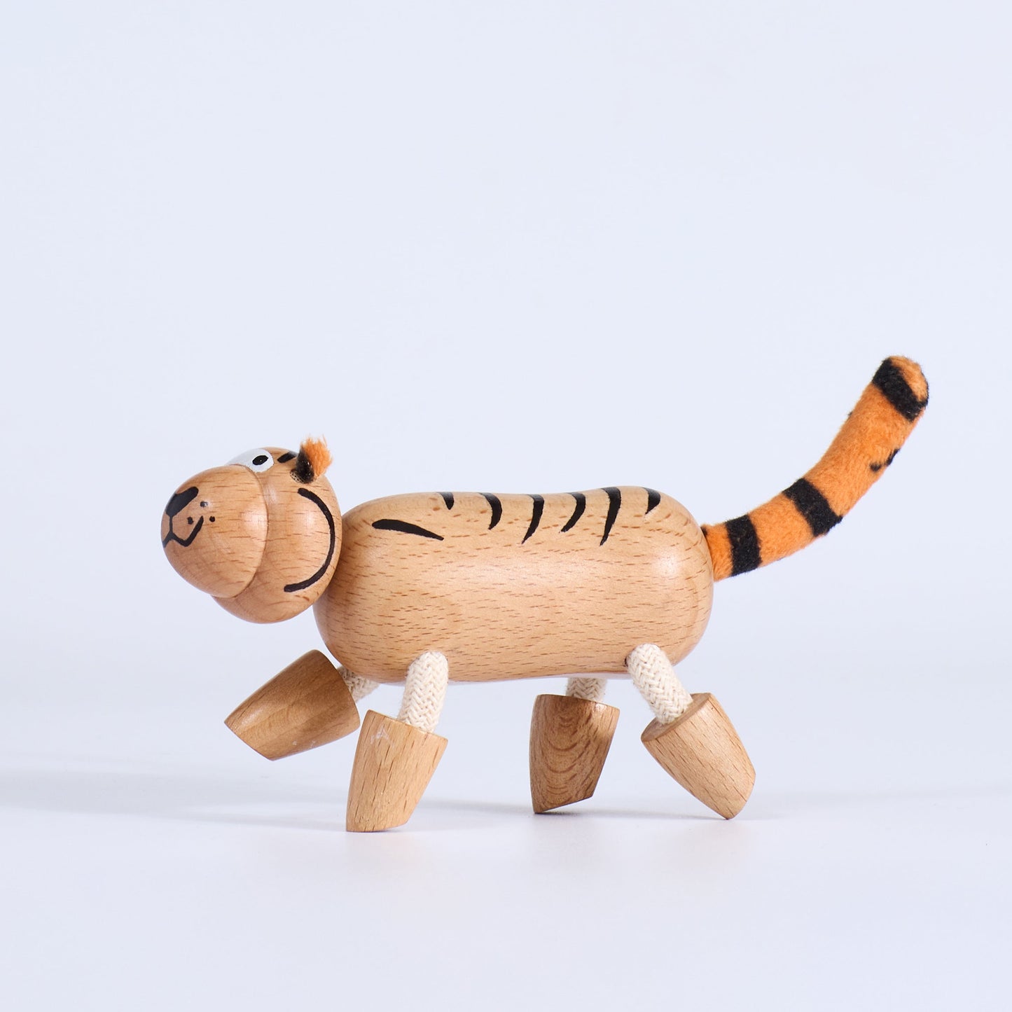 Wooden tiger toy on a light gray background