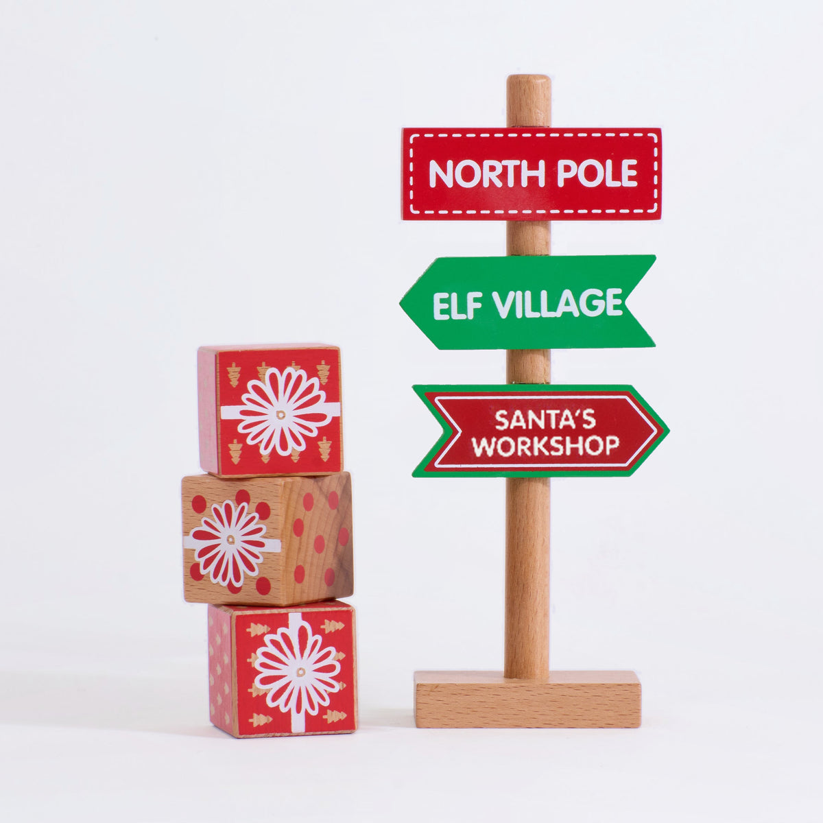 Square detail of the Christmas direction sign beside all three wooden present blocks