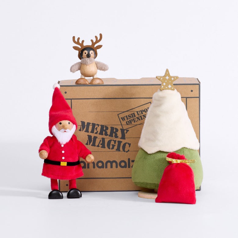 Cheery Santa gift set arranged in front of a Merry Magic box with the baby penguin perched above