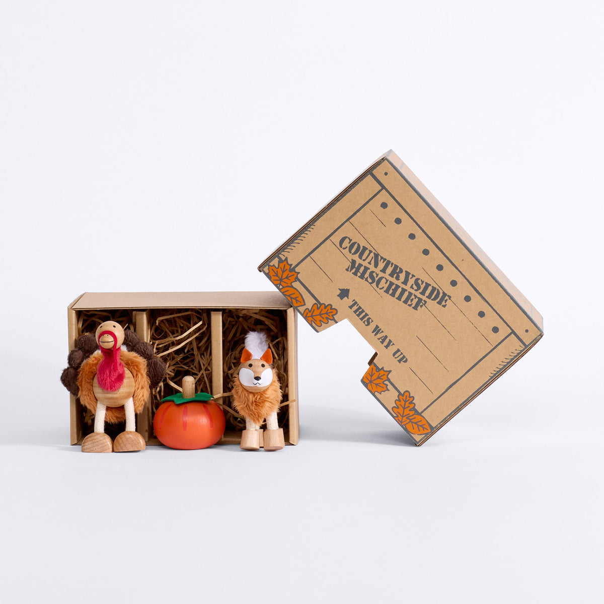 Open Harvest Mini Crate with turkey, pumpkin and fox figures, straw filling and autumn-leaf lid beside the box