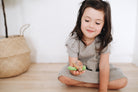 Adorable eco-friendly wooden turtle toy with fabric flippers and a smiling face, perfect for imaginative play and learning.